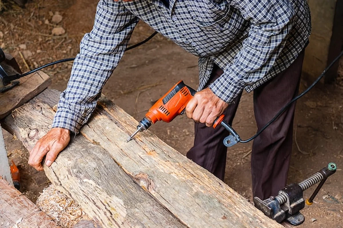 Stolarz wierci drewno